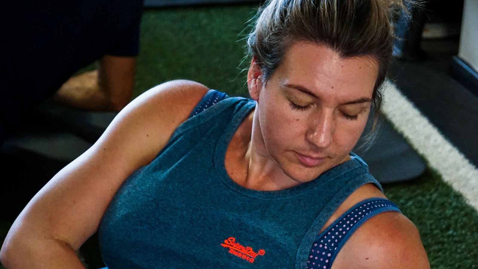 A member in her forties training with a medicine ball at Core Studio, Blackheath
